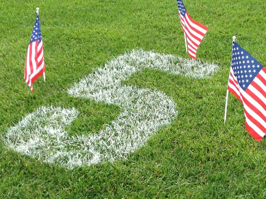 June 2, 2013: Before Ellis wore the police badge in Bardstown, he proudly wore the number 5 on Glen Este's baseball field. Sunday night the number was painted on the diamond as more than 100 people gathered in a memorial.