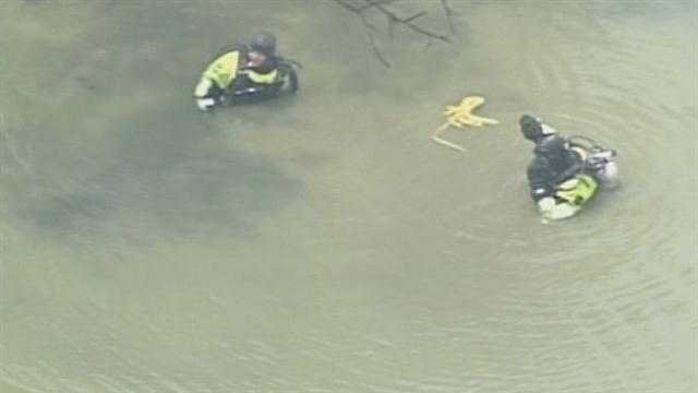 June 27, 2013: Police returned to the scene where Officer Jason Ellis was killed. The Louisville Metro Police Department dive team searched a nearby pond after a K-9 unit indicated there might be something there.