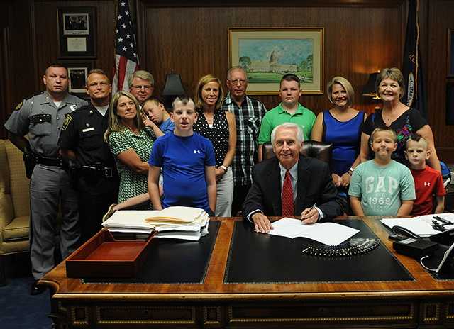 June 25, 2014: Gov. Steve Beshear signs a bill during a private ceremony with Ellis' family renaming a stretch of the Bluegrass Parkway in Bardstown in honor of Ellis.