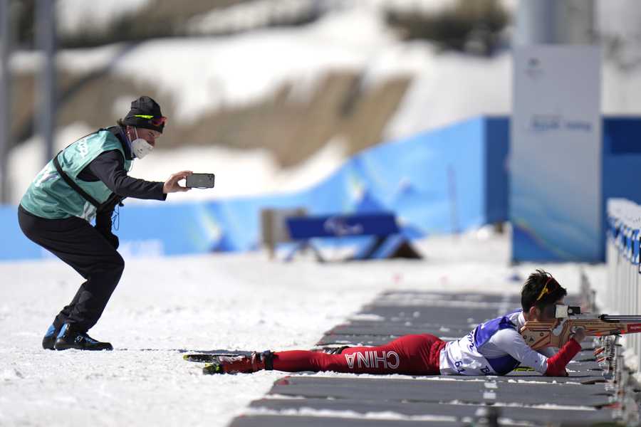 A jury records China's Liu Xiaobin shooting during the men's middle distance standing event at the 2022 Winter Paralympics, Tuesday, March 8, 2022, in Zhangjiakou, China.