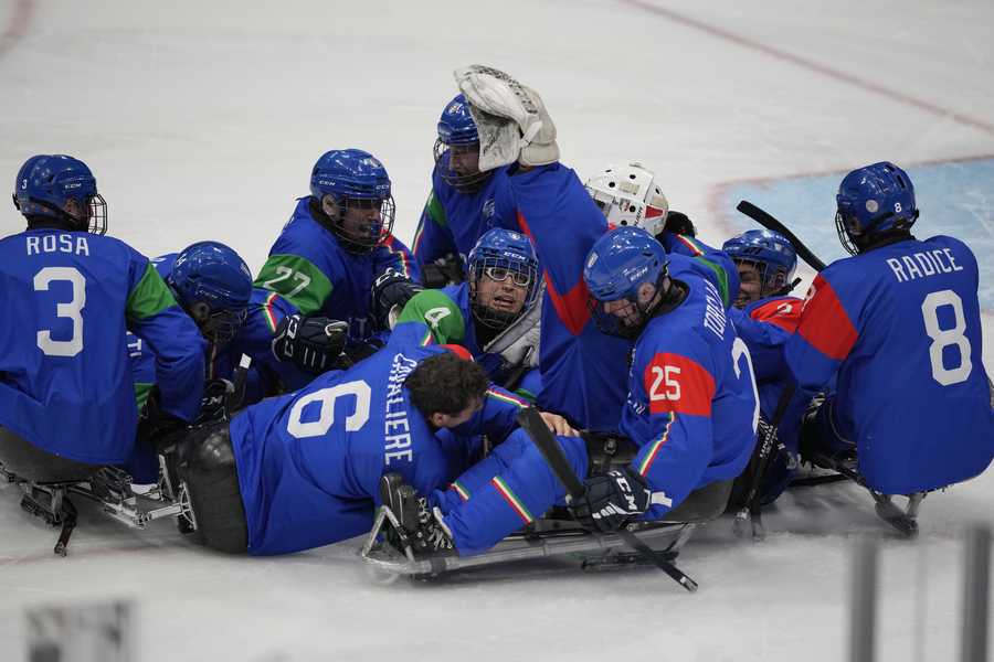 Italian players celebrate their victory over Slovakia during their para ice hockey match at the 2022 Winter Paralympics, Sunday, March 6, 2022, in Beijing.