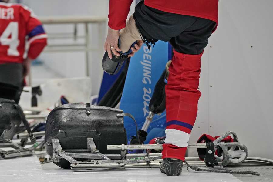 Czech Republic's Jiri Raul prepares to get into his sledge during his para ice hockey preliminary round match against Italy at the 2022 Winter Paralympics, Saturday, March 5, 2022, in Beijing.