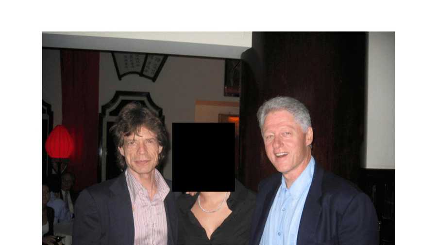 This undated, redacted photo released by the U.S. Department of Justice shows Mick Jagger, left, and former President Bill Clinton, right, with an unknown person. (U.S. Department of Justice via AP)