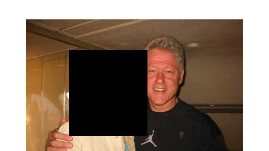 This undated, redacted photo released by the U.S. Department of Justice shows former President Bill Clinton with an unknown person. (U.S. Department of Justice via AP)