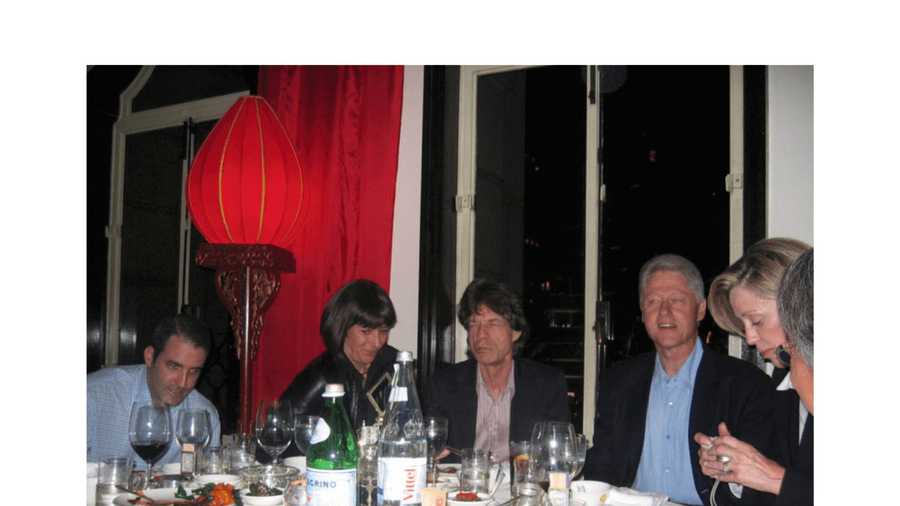 This undated photo released by the U.S. Department of Justice shows Ghislaine Maxwell, second from left, next to Mick Jagger, center, and former President Bill Clinton, third from right. (U.S. Department of Justice via AP)