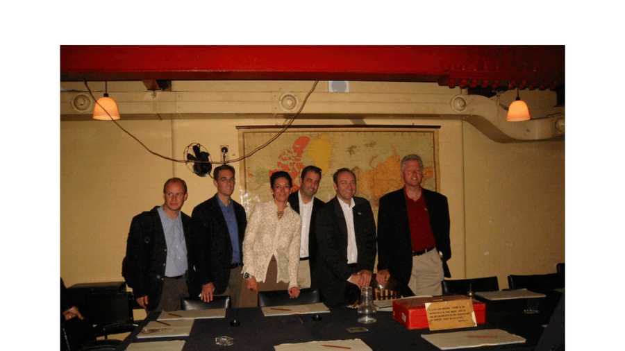 This undated photo released by the U.S. Department of Justice shows Ghislaine Maxwell, third from left, and former President Bill Clinton, far right, with a group of unknown people. (U.S. Department of Justice via AP)