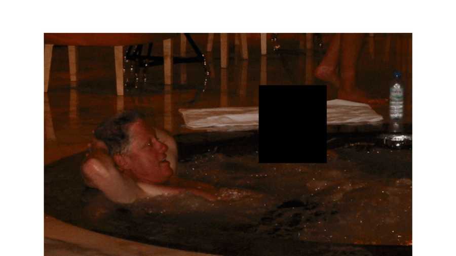 This undated, redacted photo released by the U.S. Department of Justice shows former President Bill Clinton in a hot tub with an unknown person. (U.S. Department of Justice via AP)