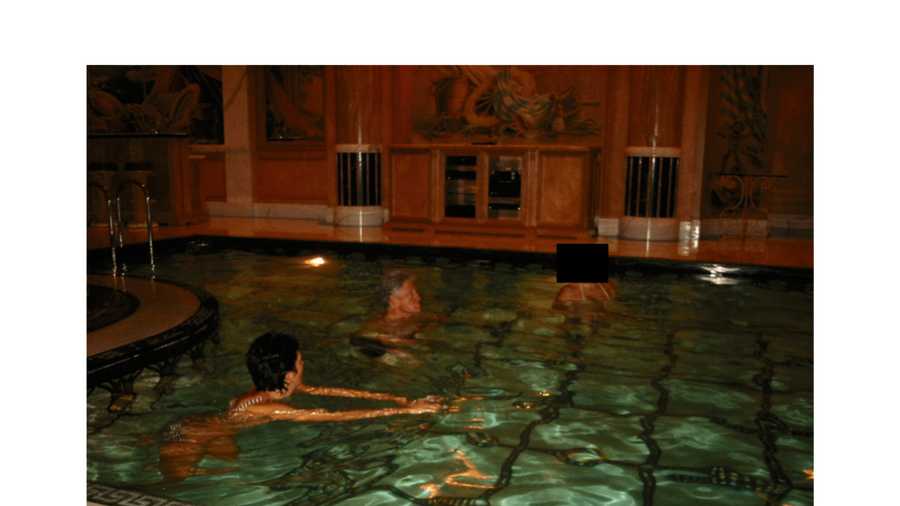 This undated, redacted photo released by the U.S. Department of Justice shows Ghislaine Maxwell and former President Bill Clinton swimming with an unknown person. (U.S. Department of Justice via AP)
