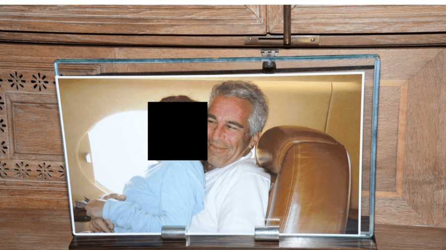 This redacted photo released by the U.S. Department of Justice shows a framed photograph of Jeffrey Epstein with a person on his lap, documented on Aug. 12, 2019, during a search of his home on Little St. James island in the U.S. Virgin Islands. (U.S. Department of Justice via AP)
