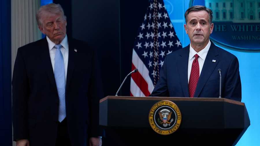 FILE - CIA Director John Ratcliffe, accompanied by President Donald Trump, speaks with reporters in the James Brady Press Briefing Room at the White House in Washington, April 6, 2026, File)
