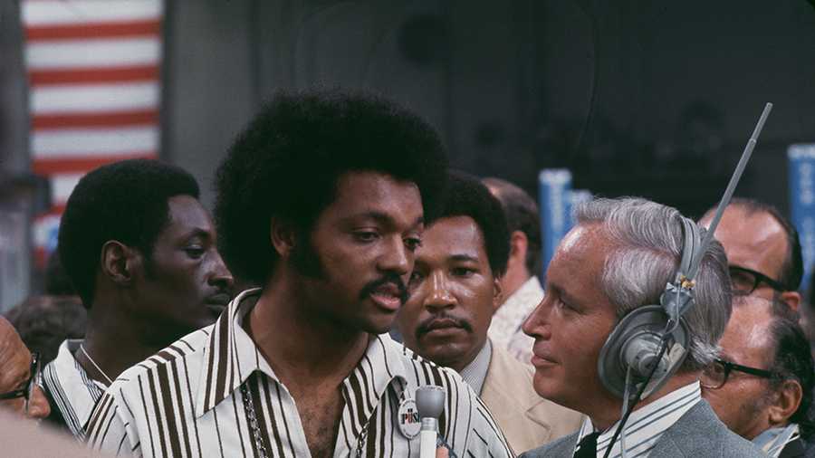 American civil rights activist Jesse Jackson is interviewed by a man wearing headphones and holding a microphone at the 1972 Democratic National Convention, held at the Miami Beach Convention Center in Miami Beach, Florida, United States, July 1972. (Photo by Pictorial Parade/Archive Photos/Getty Images)