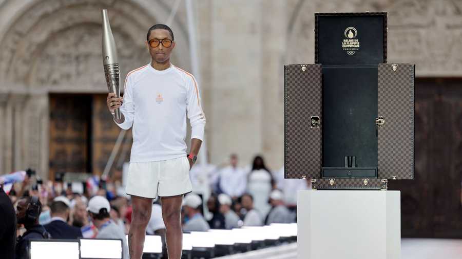 SAINT-DENIS, FRANCE - JULY 26: US rapper, artist and designer Pharell Williams during the 2024 Paris Olympic Games Torch Relay, on the day of the opening ceremony, on July 26, 2024 in Saint-Denis, outside Paris. (Photo by Stephane De Sakutin - Pool/Getty Images)