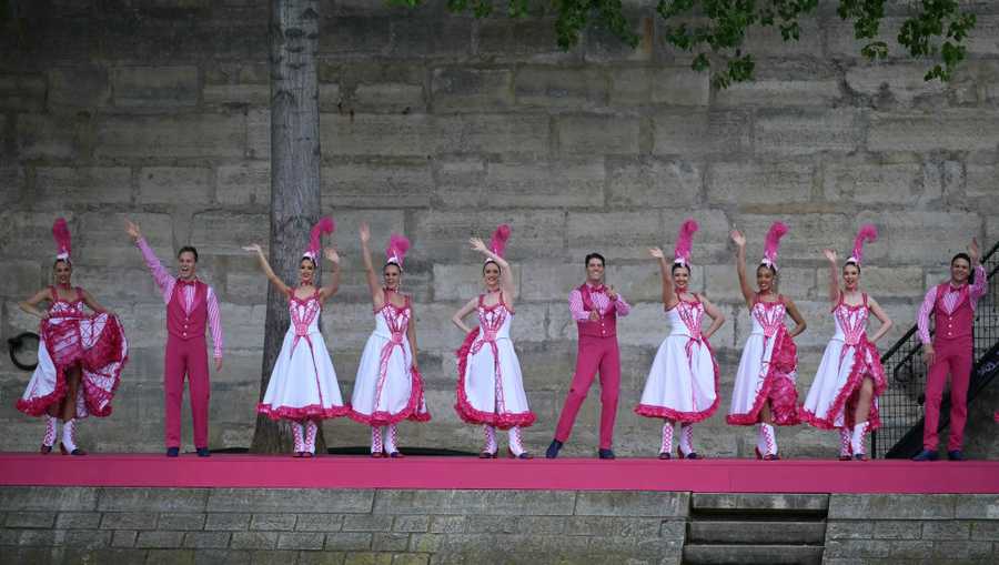 PARIS, FRANCE - JULY 26: Dancers performing French Cancan choreography as part of one of twelve artistic tableaux, are pictured from the boat of Brazil&apos;s delegation  sailing along the river Seine during the opening ceremony of the Olympic Games Paris 2024 on July 26, 2024 in Paris, France. (Photo by Carl de Souza-Pool/Getty Images)