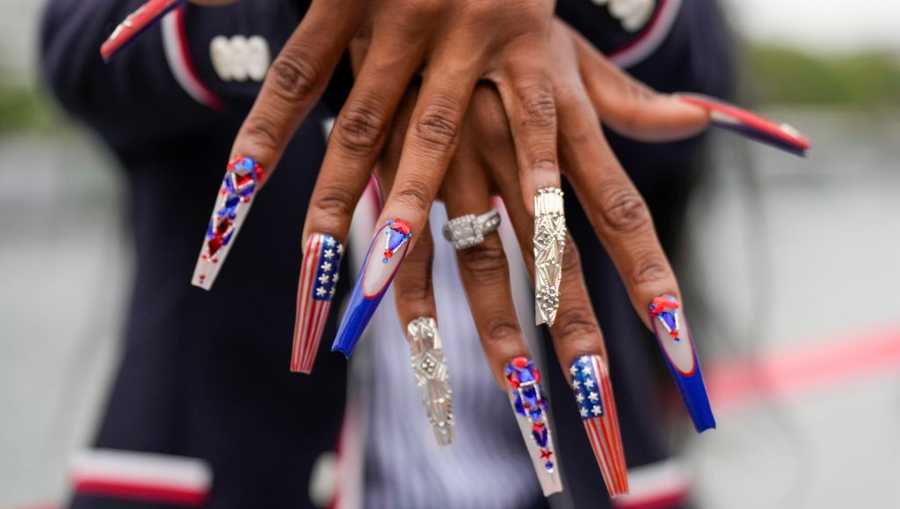PARIS, FRANCE - JULY 26: Sha&apos;Carri Richardson, of the United States, shows off her nails while traveling along the Seine River in Paris, France, during the opening ceremony of the 2024 Summer Olympics, Friday, July 26, 2024. (Photo by Ashley Landis - Pool/Getty Images)