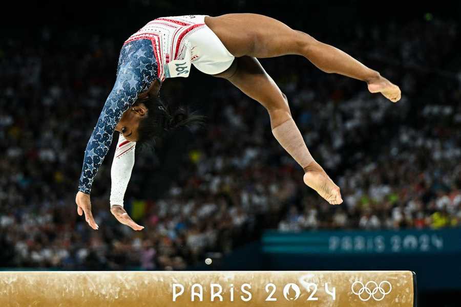 TOPSHOT - US&apos; Simone Biles competes in the balance beam event of the artistic gymnastics women&apos;s team final during the Paris 2024 Olympic Games at the Bercy Arena in Paris, on July 30, 2024. (Photo by Gabriel BOUYS / AFP) (Photo by GABRIEL BOUYS/AFP via Getty Images)