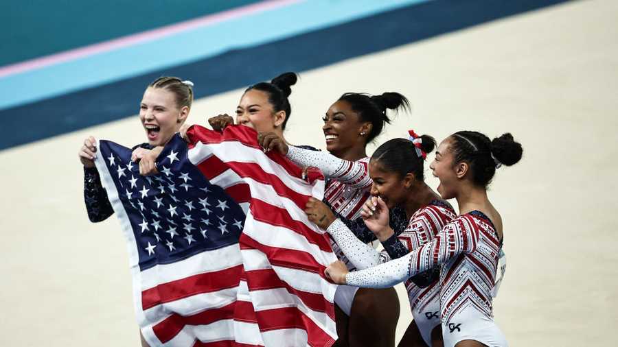 USA team celebrates after winning the artistic gymnastics women&apos;s team final during the Paris 2024 Olympic Games at the Bercy Arena in Paris, on July 30, 2024. (Photo by Anne-Christine POUJOULAT / AFP) (Photo by ANNE-CHRISTINE POUJOULAT/AFP via Getty Images)