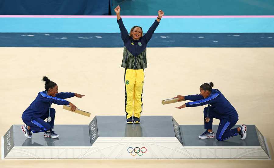 PARIS, FRANCE - AUGUST 05: Gold medalist Rebeca Andrade (C) of Team Brazil, silver medalist Simone Biles (L) of Team United States and bronze medalist Jordan Chiles (R) of Team United States celebrate on the podium at the Artistic Gymnastics Women&apos;s Floor Exercise Medal Ceremony on day ten of the Olympic Games Paris 2024 at Bercy Arena on August 05, 2024 in Paris, France. (Photo by Elsa/Getty Images)
