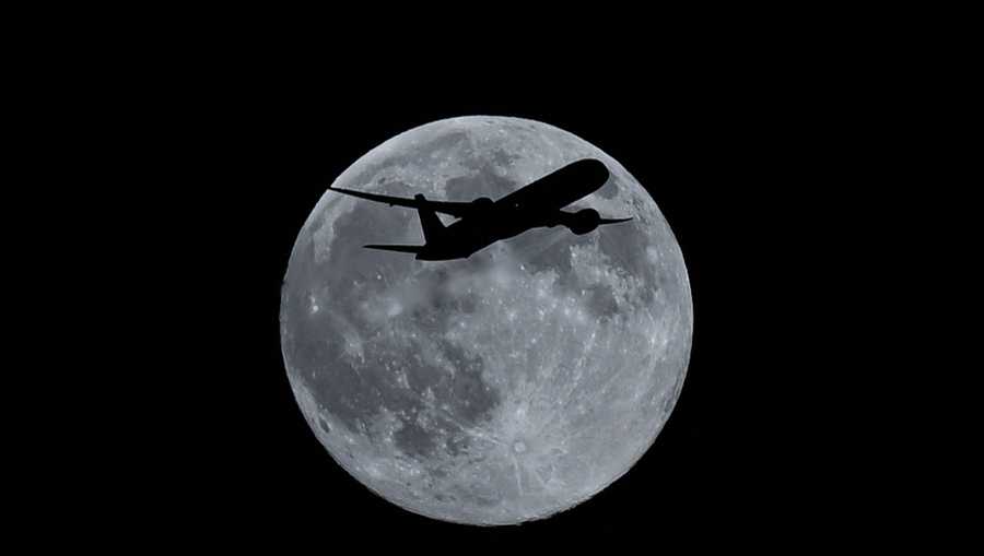 LONDON, UNITED KINGDOM - DECEMBER 4: Silhouette of a plane in front of full moon appeared in the sky in London, United Kingdom, on December 4, 2025. (Photo by Rasid Necati Aslim/Anadolu via Getty Images)