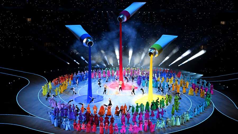 A general view of a parade of performers dressed as symbols of Italian imagination and creativity during the opening ceremony of the Milano Cortina 2026 Winter Olympics at San Siro Stadium.