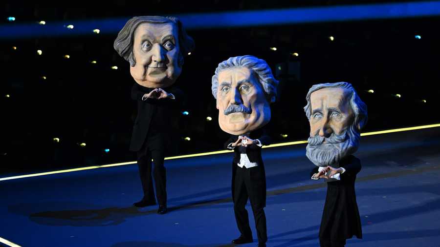 Actors dressed as the great masters of Italian Opera, Giuseppe Verdei, Giacomo Puccini, and Gioachino Rossini perform during the opening ceremony of the Milano Cortina 2026 Winter Olympics at San Siro Stadium on February 06, 2026 in Milan, Italy.