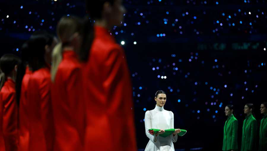 Vittoria Ceretti, flagbearer for Milano, caries the Italian flag during the opening ceremony of the Milano Cortina 2026 Winter Olympics at San Siro Stadium on February 06, 2026 in Milan, Italy.