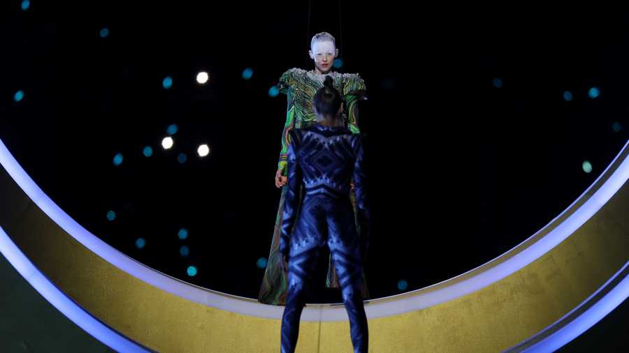 Two actors performing inside rings representing the city and mountain during the opening ceremony of the Milano Cortina 2026 Winter Olympics at San Siro Stadium on February 06, 2026, in Milan, Italy.