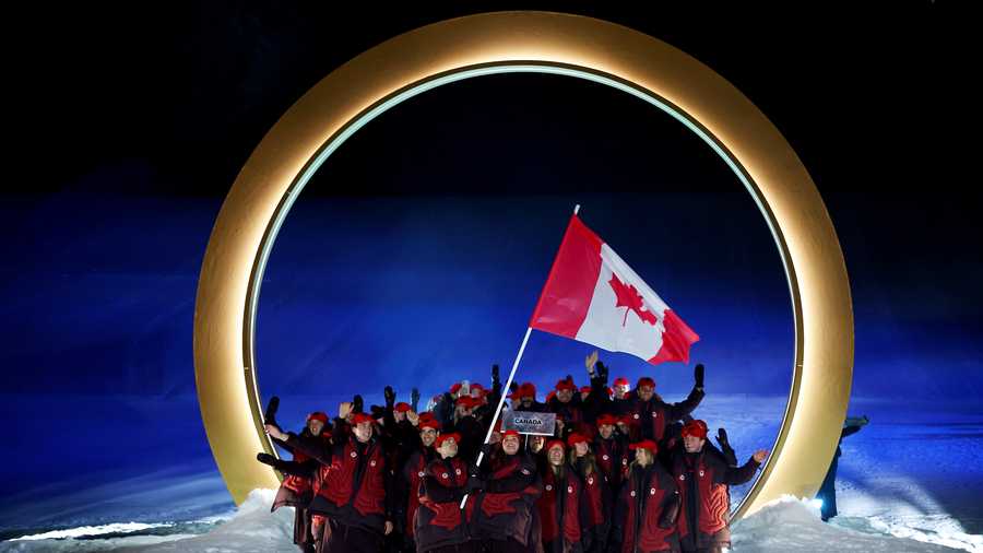Marielle Thompson and Mikael Kingsbury, flagbearers of Team Canada, enter with the team into the stadium during the opening ceremony of the Milano Cortina 2026 Winter Olympics at Livigno Snow Park on February 06, 2026 in Livigno, Italy.