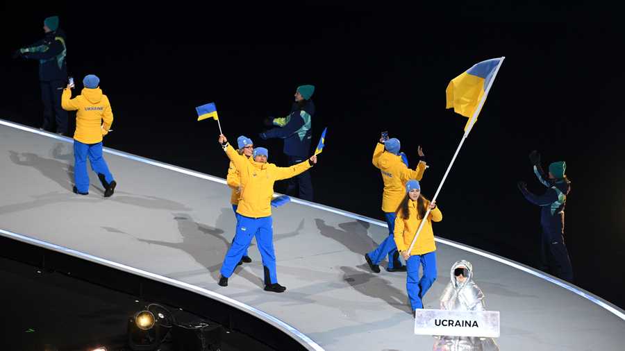 Flagbearer Yelyzaveta Sydorko of Team Ukraine enters with the team into the stadium during the opening ceremony of the Milano Cortina 2026 Winter Olympics at San Siro Stadium on February 06, 2026 in Milan, Italy.
