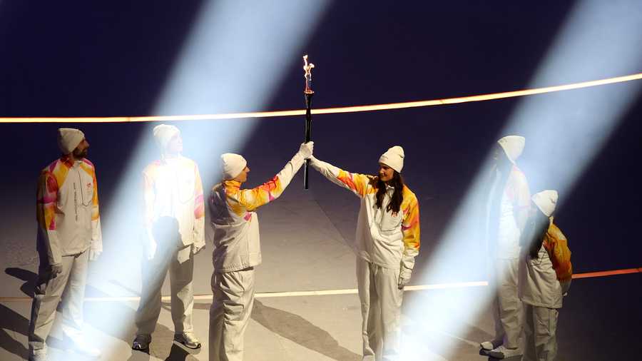 Athletes of Team Italy handover the Olympic flame to the next group of Torchbearers during the opening ceremony of the Milano Cortina 2026 Winter Olympics at San Siro Stadium on Feb. 6.