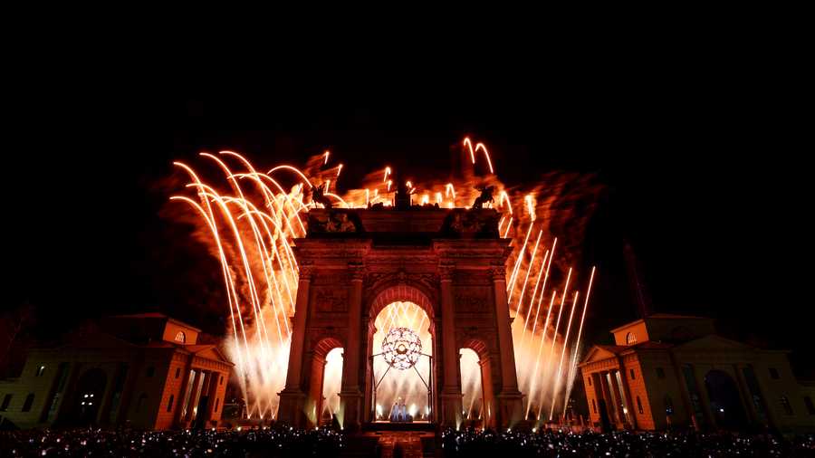 A pyrotechnic display takes place as torchbearers Deborah Compagnoni and Alberto Tomba light the Olympic cauldron during the opening ceremony of the Milano Cortina 2026 Winter Olympics at Piazza Dibona on February 06, 2026 in Milan, Italy.