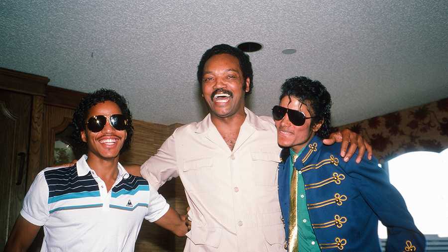 In a hotel room during the 1984 Democratic National Convention, American sibling pop singers Marlon (left) and Michael Jackson (right) attend a press conference with politician Jesse Jackson, San Francisco, California, mid July, 1984. Jesse Jackson was a hopeful for the Democratic presidential nomination, though he lost to Walter Mondale., San Francisco, California, mid July, 1984. Jesse Jackson was a hopeful for the Democratic presidential nomination, though he lost to Walter Mondale.. (Photo by Robert R. McElroy/Getty Images)