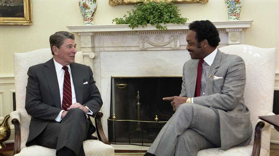 washington, dc: the reverend jesse jackson (right) chats with president reagan in the oval office, february 25. jackson said he appealed to the president to restore $25 billion in education budget cuts and to increase pressure on south africa.