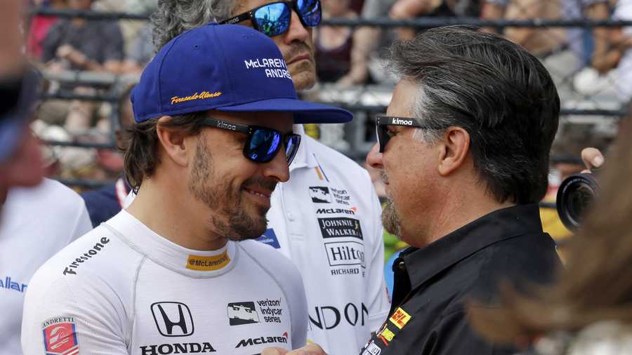 Fernando Alonso, of Spain, enter, Takuma Sato, of Japan, right and JR Hildebrand are introduced before the Indianapolis 500 auto race at Indianapolis Motor Speedway, Sunday, May 28, 2017 in Indianapolis. (AP Photo/Sam Riche)