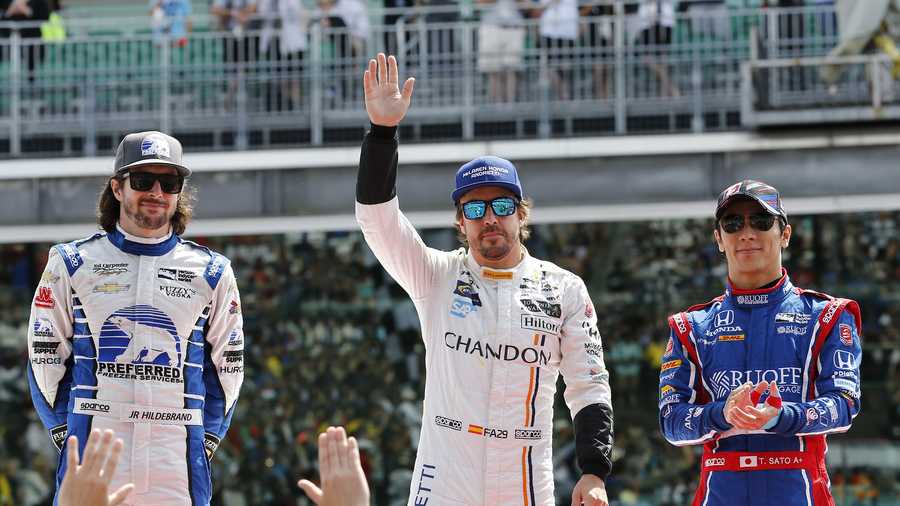 Fernando Alonso, of Spain, enter, Takuma Sato, of Japan, right and JR Hildebrand are introduced before the Indianapolis 500 auto race at Indianapolis Motor Speedway, Sunday, May 28, 2017 in Indianapolis. (AP Photo/Sam Riche)