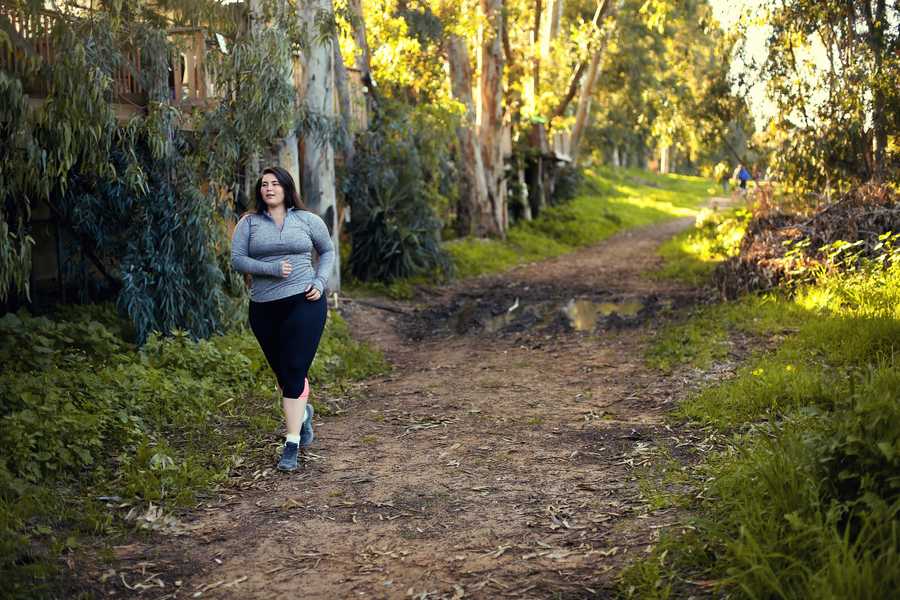 Plus size women jogging and exercising at the park