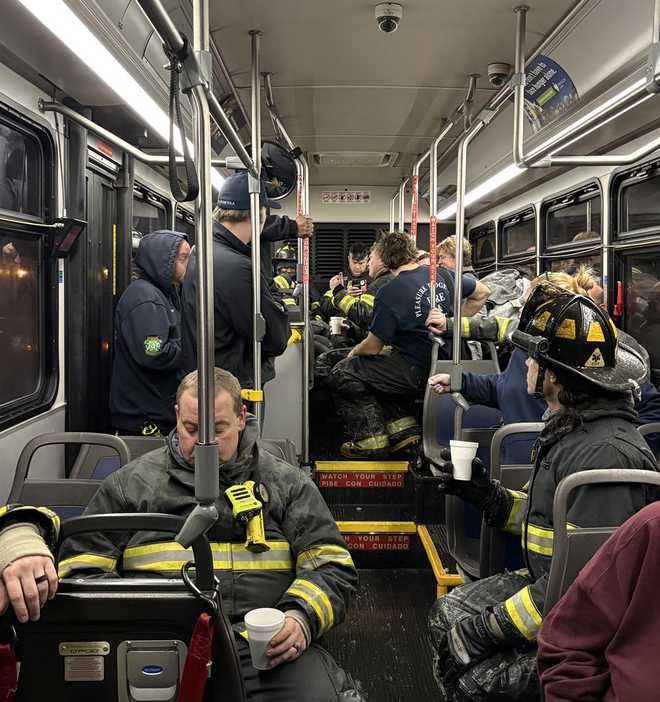 firefighters warming up on a tarc bus