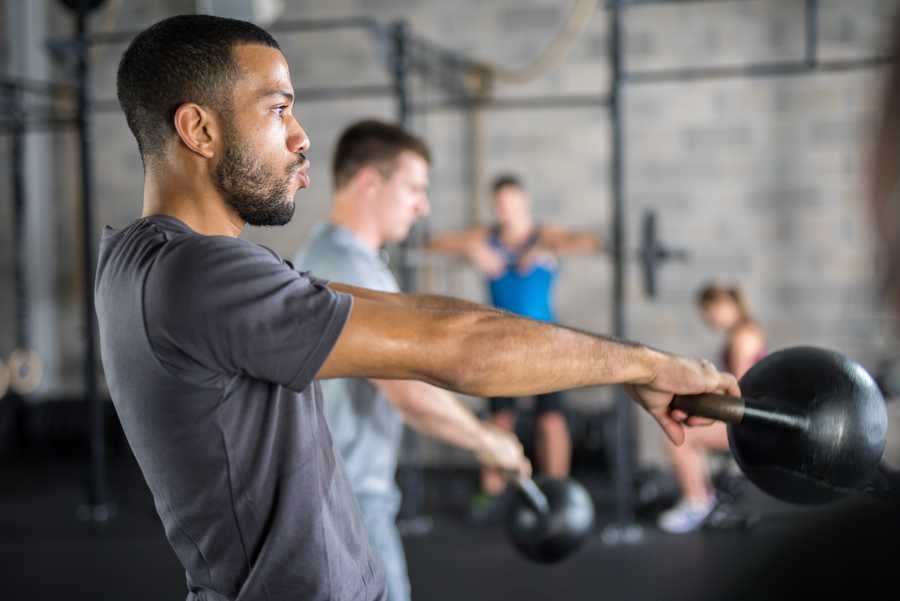Young man exercising in gym